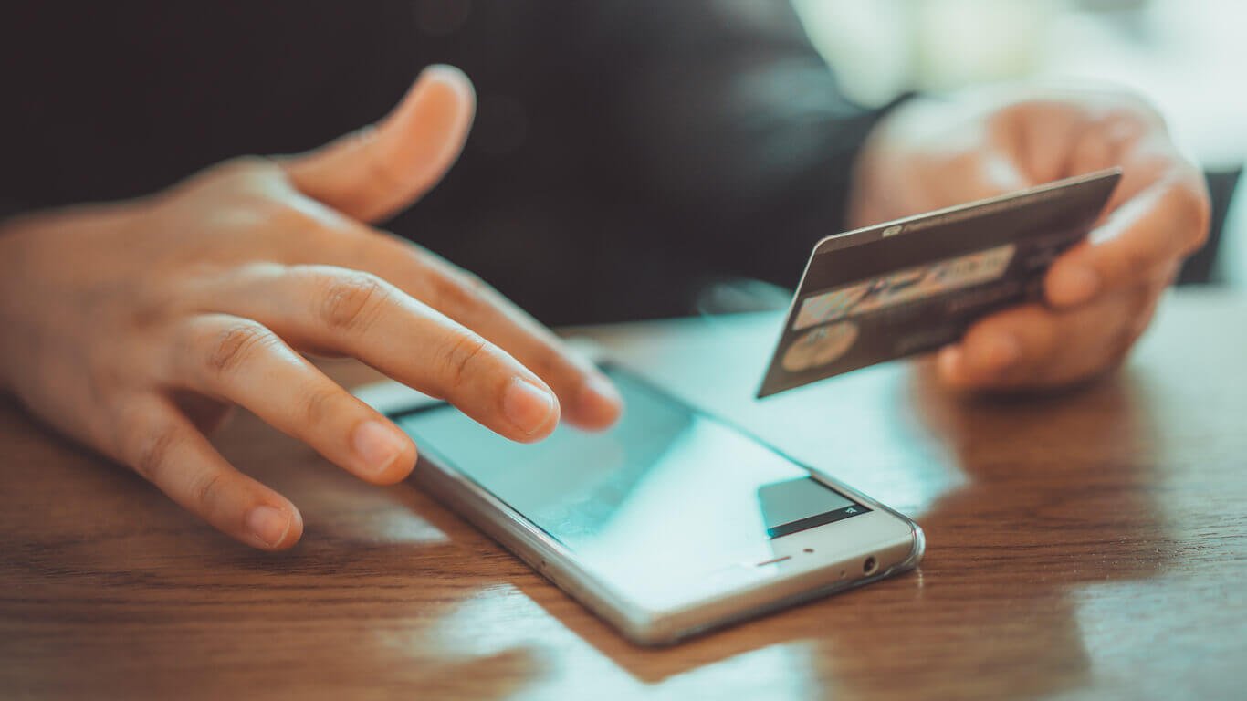 Man Entering Card Details into Phone
