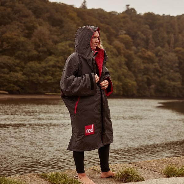 Woman Wearing Grey Long Sleeve Red Original Waterproof Changing Robe standing on a river bank